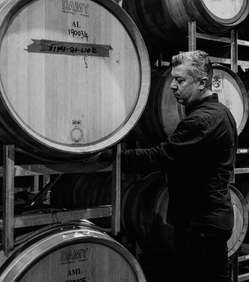 Frank Mitolo inspects wine barrels in the McLaren Vale winery